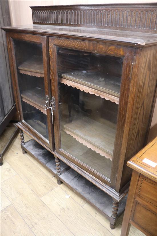 A 1920s glazed two door bookcase, W.120cm